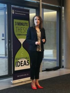Maria-Elizabeth Baeva presenting in front of a banner at the UBC Three Minute Thesis (3MT) in 2019, an academic competition where graduate students explain their research project to a non-specialist audience in just under three minutes. 