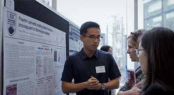 CBR student presenting their poster at a symposium