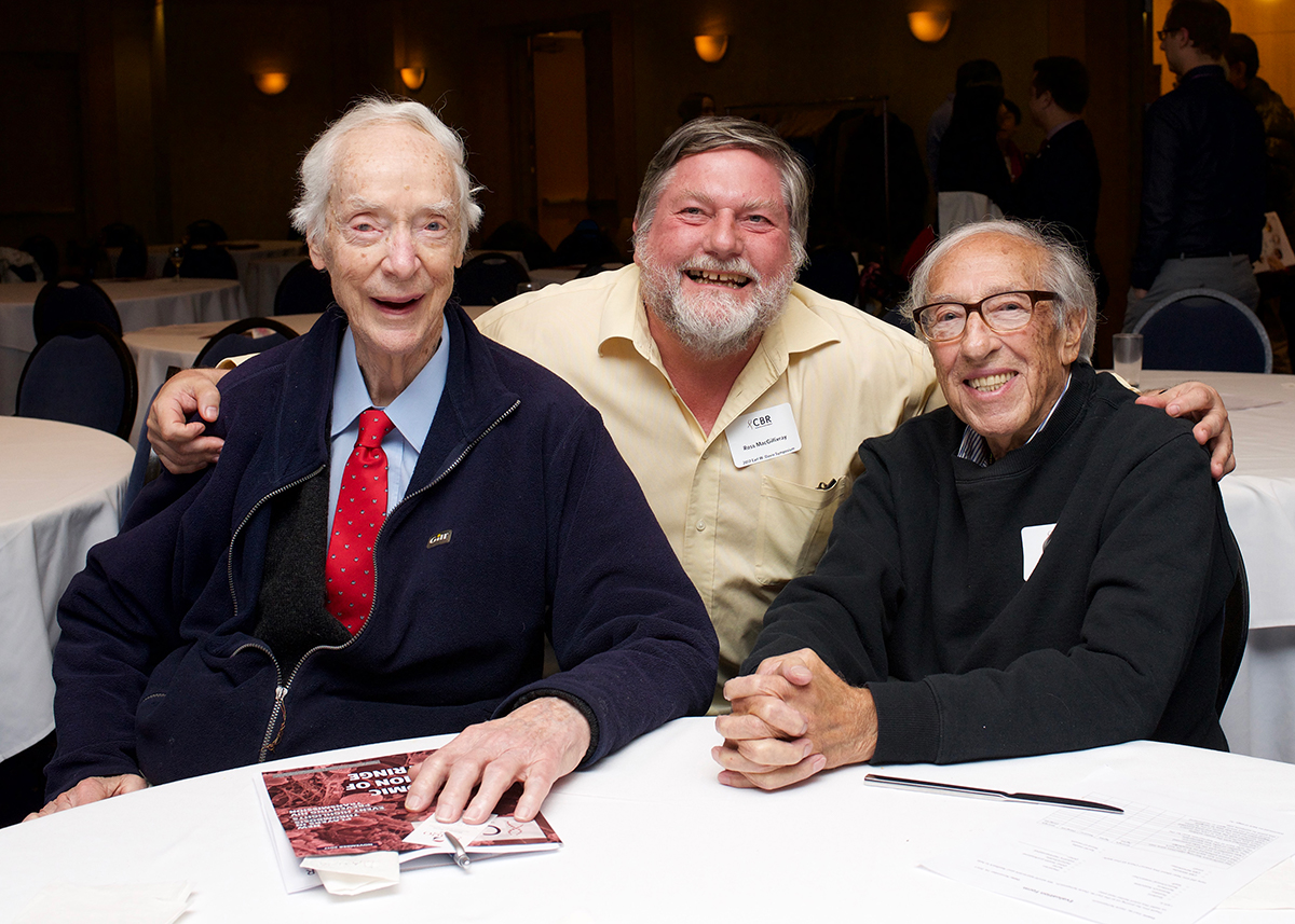 Group photo of Dr. Earl W. Davie, Dr. Ross MacGillivray and Dr. Eddy Fischer (from left to right) seated at a table during the Earl W. Davie Symposium in 2017.