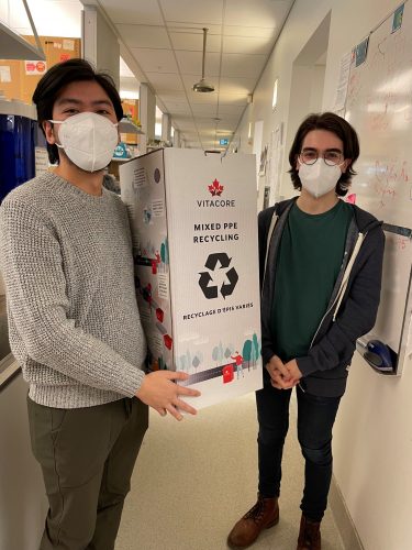 CBR members Daniel Luo (left) and Matthew Drayton (right) bringing recycling boxes to promote lab sustainability into their lab