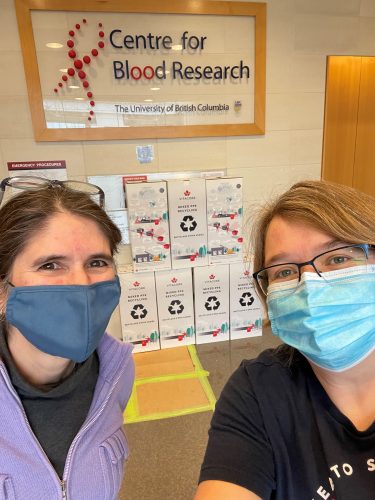 Dr. Katherine Serrano (left) and Dr. Reinhild Kappelhoff (right) posing with the recycling boxes to increase lab sustainability.