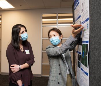 Poster presenter Pan Deng shares her research to attendee and oral talk presenter Dr. Narges Hadjesfandiari