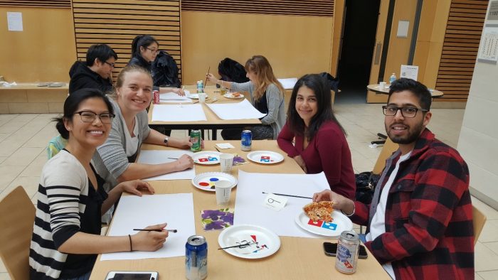 Attendees participating in the "Paint Your Thesis" activity